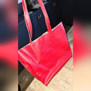 Red tote bag with attached floral clutch